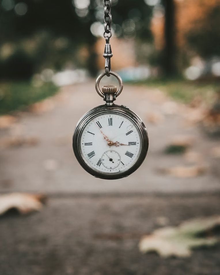 A pocket watch swinging on its chain